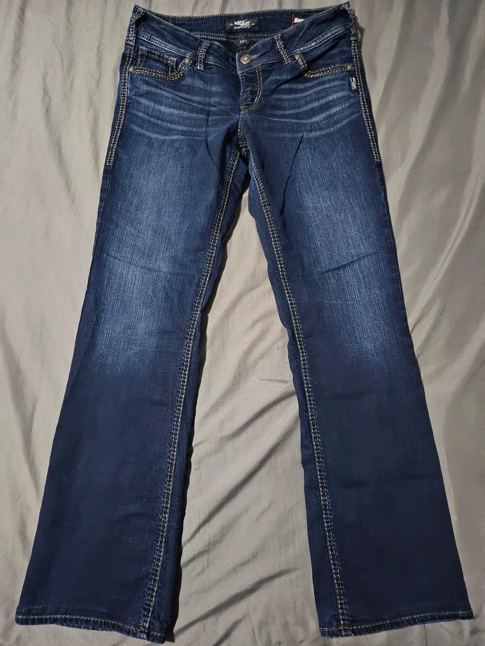 Dark wash bootcut jeans with contrast stitching and faded whiskering